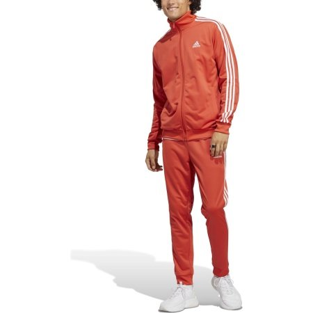 Adidas oranžinis vyriškas sportinis kostiumas su baltomis juostelėmis – klasikinio kirpimo, iš trikotažo, su šoninėmis kišenėmis. M 3s Tracksuit Basics IC6786