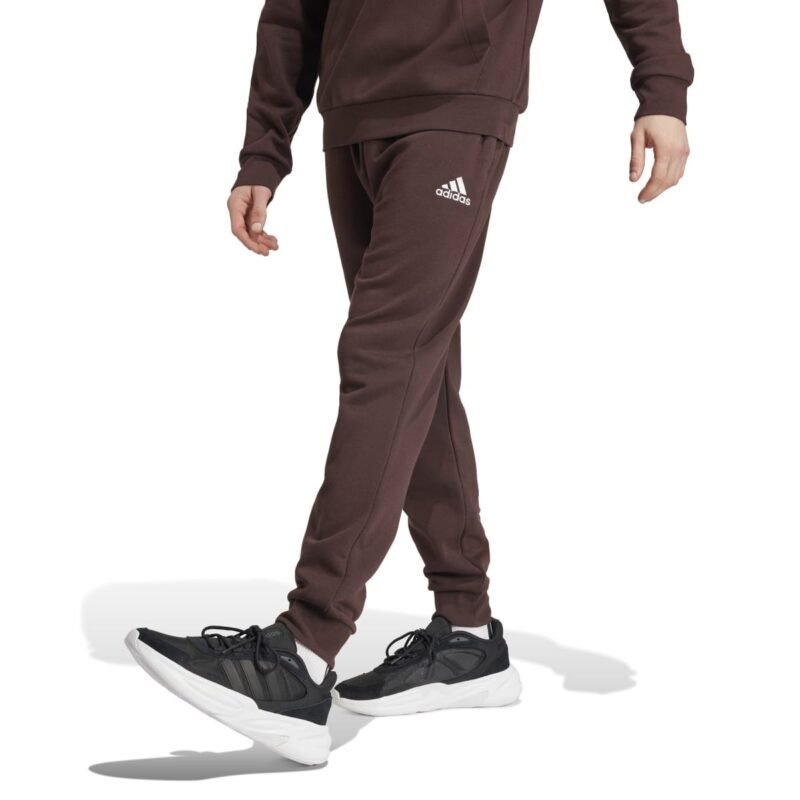 Adidas Essentials Fleece Regular Tapered Pants IY9086 – rudos vyriškos sportinės kelnės su minkštu „fleece“ pamušalu ir reguliuojamu juosmeniu.
