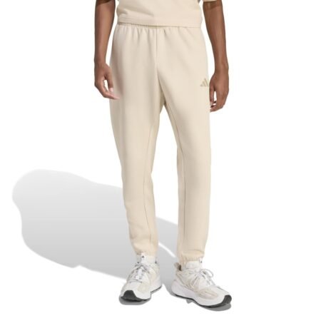 Šviesiai kreminės vyriškos Adidas Future Icons sportinės kelnės su siaurėjančiomis klešnėmis ir mažu logotipu, modelis KD7641.